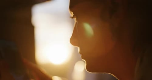 Woman Using Cell Phone at Sunrise, Close Up