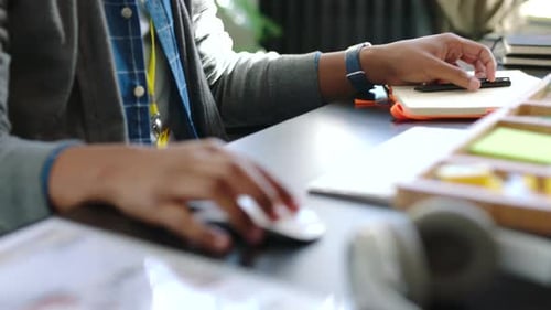 Businessman writing notes, reading documents report and doing creative research on a computer