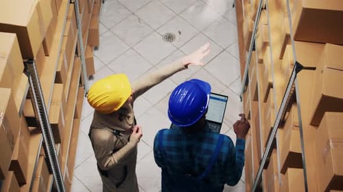 Diverse Employees Analyzing Inventory List on Laptop