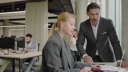 Business Professionals Collaborating on Laptop Data Review