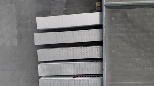 Aerial Top Down View of Semi Trucks Docking at Logistics Center