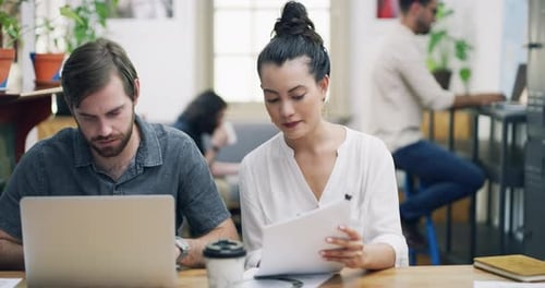 4k video footage of a young businessman and businesswoman having a meeting in a modern office