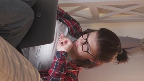 Woman Using Laptop in Cozy Indoor Setting