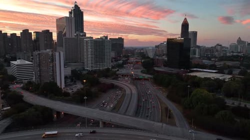 Silhouette of Atlanta Georgia skyline. Colorful sunset with traffic on interstate highway.