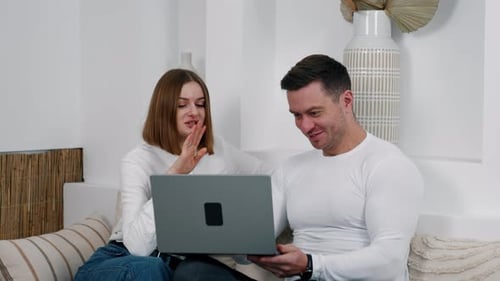Couple Using Laptop Together on Couch