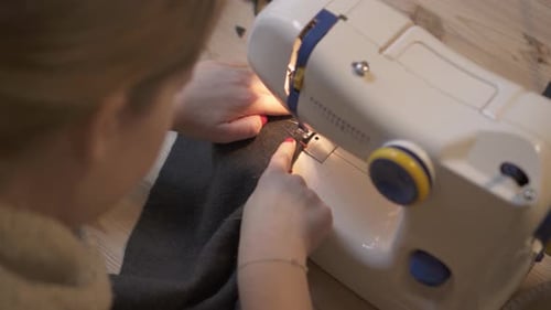 woman at the sewing machine in the workshop - close up shot