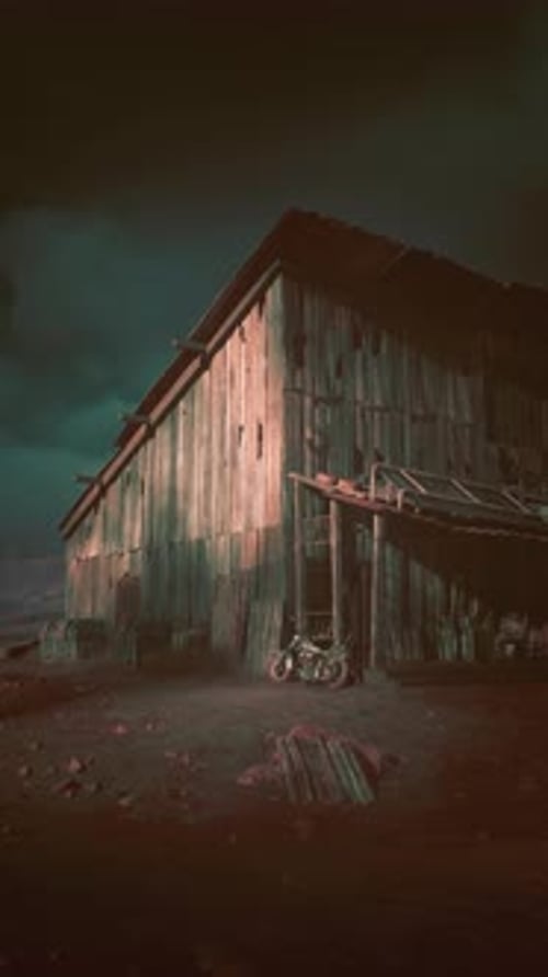 Barn Standing in Field Under Dark Sky