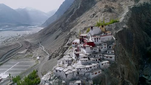 aerial view of a beautiful ancient remains of buddhist monastery located on a rugged mountain range.