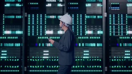 Asian Businesswoman Use Tablet While Walking and Looking Around in Data Center