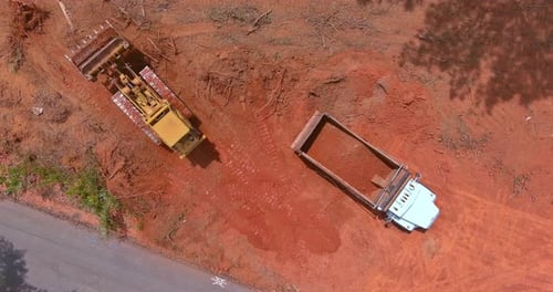 Bulldozer and Truck Moving Dirt Aerial View