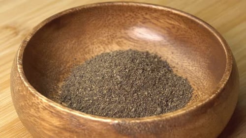Ground Black Pepper Filling Wooden Bowl