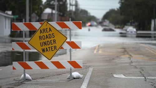 Road Closed Because of Flooding Danger with Warning Signs Blocking Driving of Cars