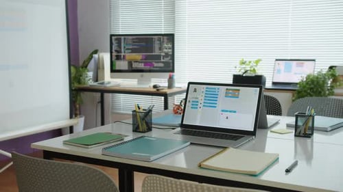Coding Application on Screen of Laptop at Equipped with Gadgets IT Classroom