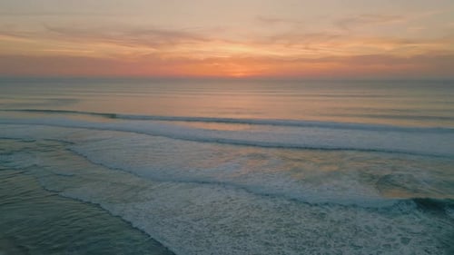 Peaceful Ocean Evening Dusk with Golden Cloudy Sky Over Endless Horizon Aerial
