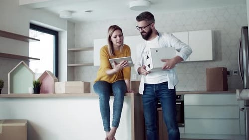 Couple Moving Into New Home Discussing Plans