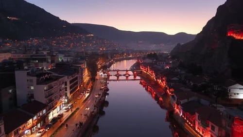 Twilight River Cityscape Surrounded by Mountains