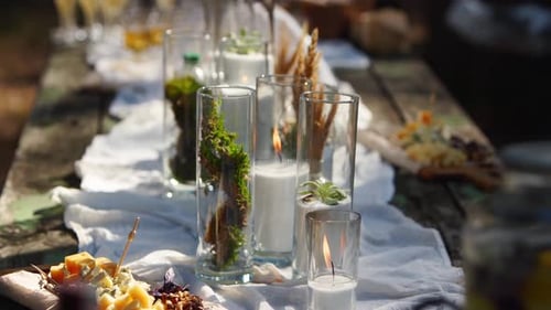 Wedding Party Banquet Outdoors in Forest Dining Table Decorated in Boho Style with Candles White