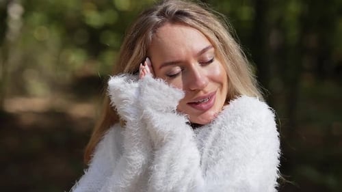 Closeup Portrait of Happy Caucasian Young Woman Standing in Sunny Forest on Summer Autumn Day