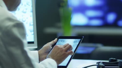 Doctor is Watching Rib Cage X-Ray Pictures on Tablet.