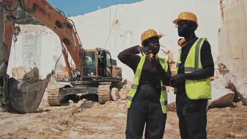 Two Quarry Workers Discussing Something