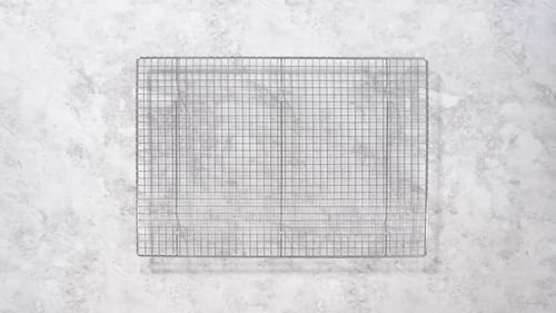 Flat Lay Step By Step Cooked Bacon Strips on a Baking Sheet with White Parchment Paper