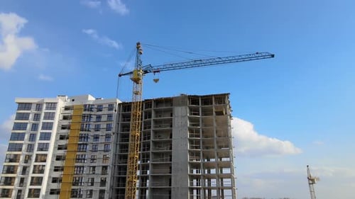 Tower Cranes and Frame Structure of High Residential Apartment Buildings at Construction Site