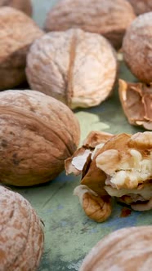 Whole Walnuts Surround a Half Open Shell
