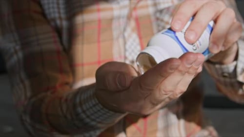 Man Takes Pill Drinks Water Close Up Bedroom