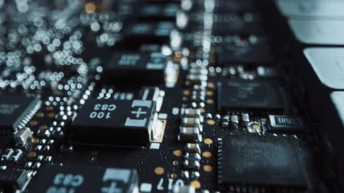 Macro Camera Moving Slowly over Printed Circuit Board, showing Computer Motherboard Components: Mic