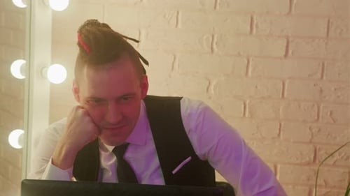 Man with dreadlocks at Computer in Workplace