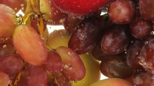 Background with fruits and berries in water with air bubbles.