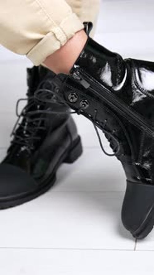 Woman Wearing Black Fashionable Lace Up Boots