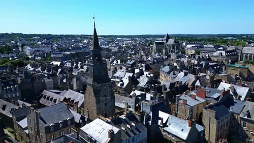 Clock tower or the Tour de l'Horloge and Saint-Malo church in background, Dinan, France. Aerial dron
