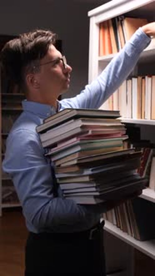 Vertical Video Librarian Organizing Books on Bookshelf in Library