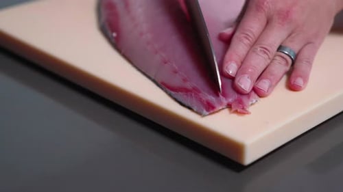 Tuna Fish Being Cut Down the Middle - Action Shot