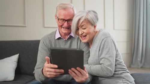 Senior Old Couple with Tablet Watching Video Online Husband Wife Spending Time Together at Home
