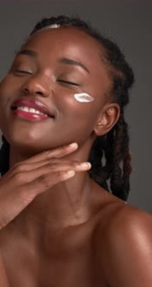 Cream, skincare and black woman with beauty, face and dermatology on gray studio background