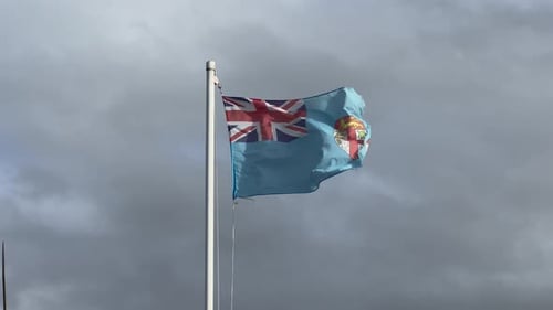 Fiji Flag Waving Against Cloudy Sky