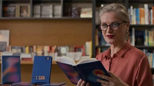 Female Author Publicly Reading Her Book during Bookstore Signing Event