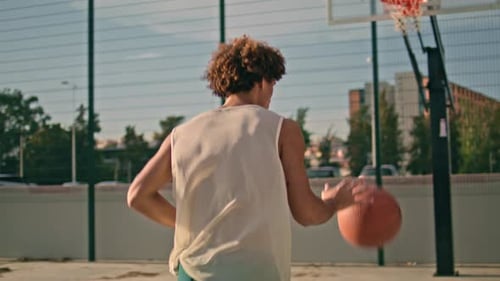 Teenager Throwing Ball Basket Back View. Modern Sportsman Playing Urban Game At