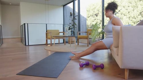 Woman Doing Tricep Dips on Sofa Indoors