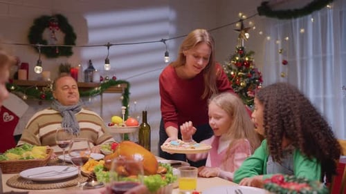 Family Celebrates Christmas with Cookies at Home