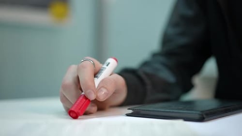 Closeup Male Hand Placing Marker at Notebook Tapping Fingers on Table