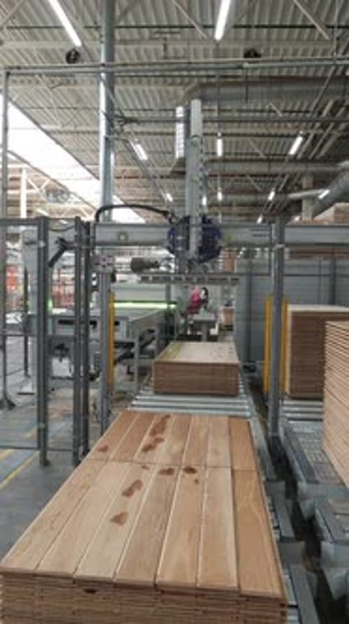 Automated Machinery Stacking Wood in Modern Factory