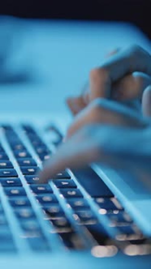 Hands Typing on Keyboard of Laptop