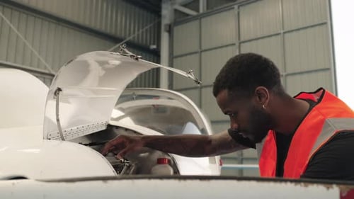 Aircraft Maintenance Engineer Inspecting Engine Compartment in Slow Motion