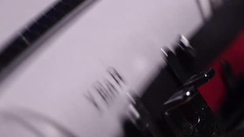 Year 1975, Typing in Vintage Typewriter on Blank White Paper, Close Up