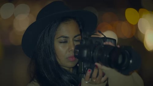 Woman Photographer Takes Photo at Night