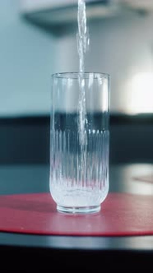 Refreshing Water Being Poured into a Glass