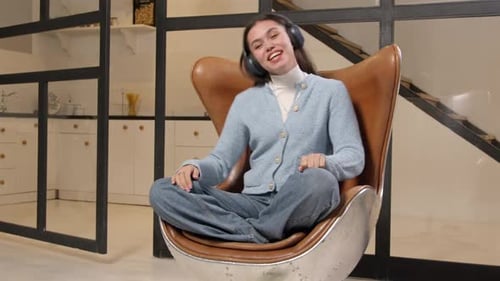 Happy Woman Listening to Music at Home